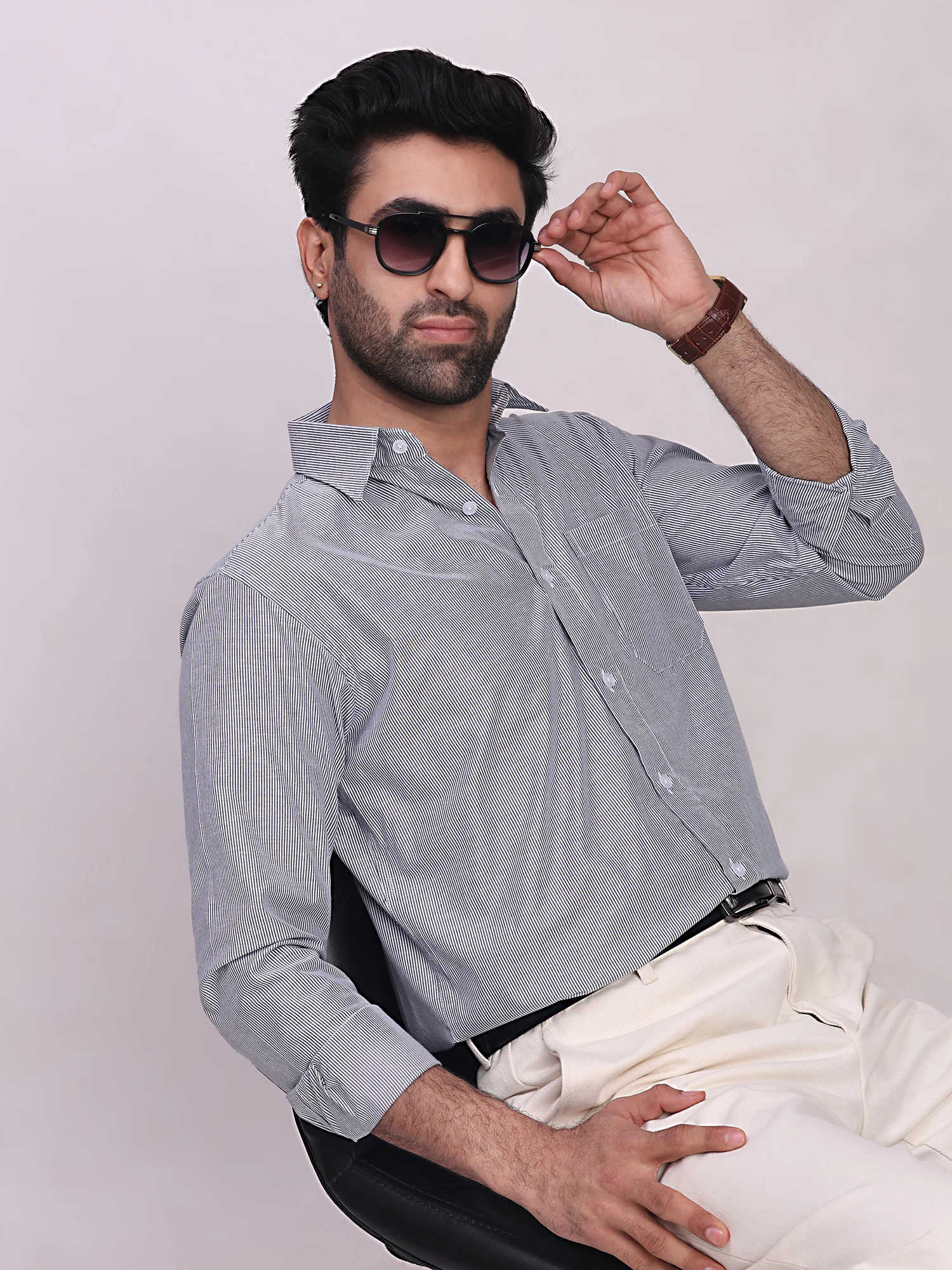 Striped shirt, light blue and white, worn by a model, front view, collar visible, long sleeves