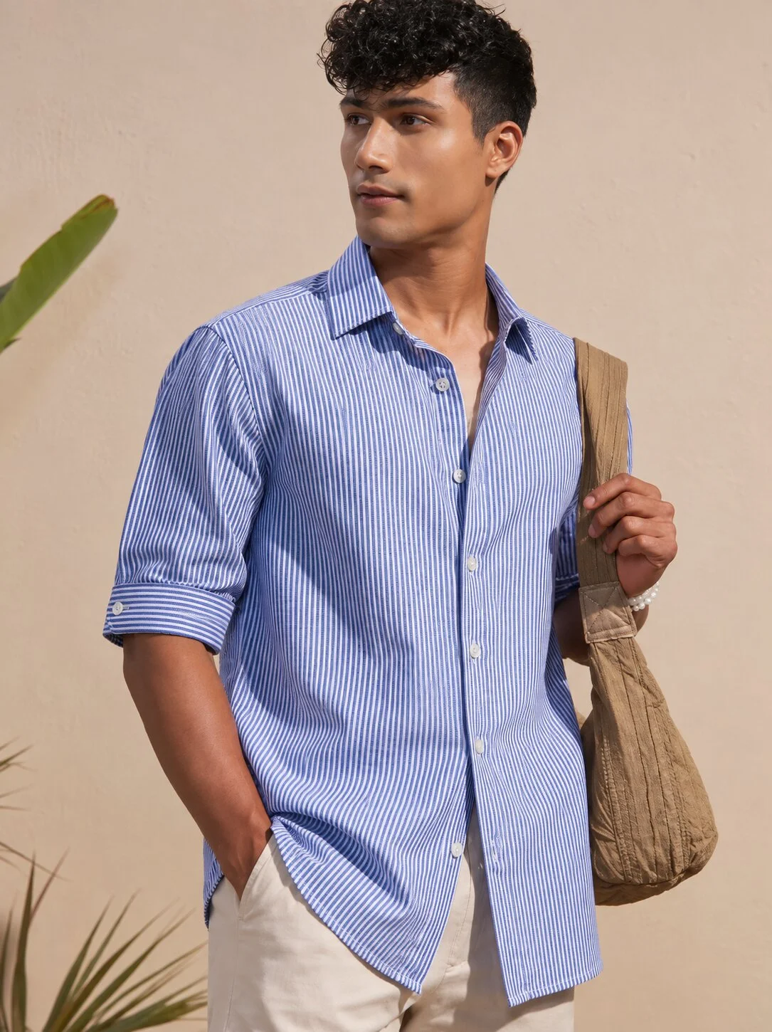 Blue and white striped short-sleeved shirt, worn by a model, buttons, collar visible
