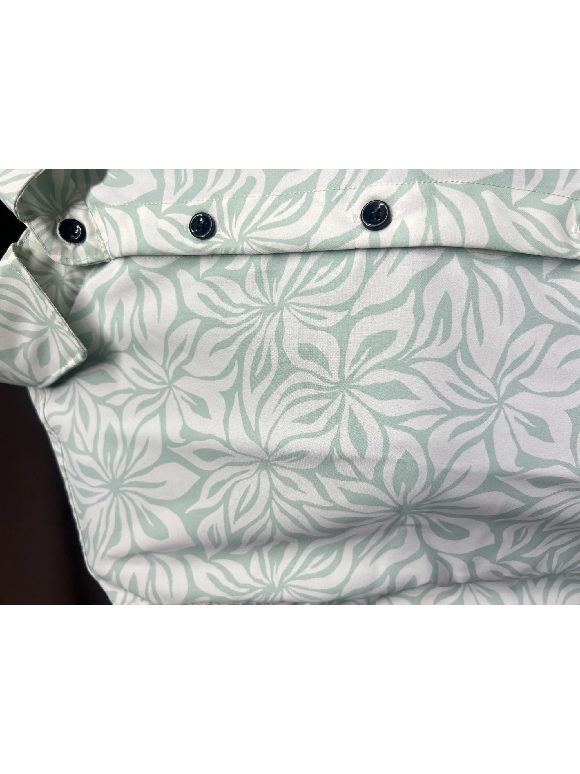 Mint green and white floral patterned shirt, close-up of collar and buttons