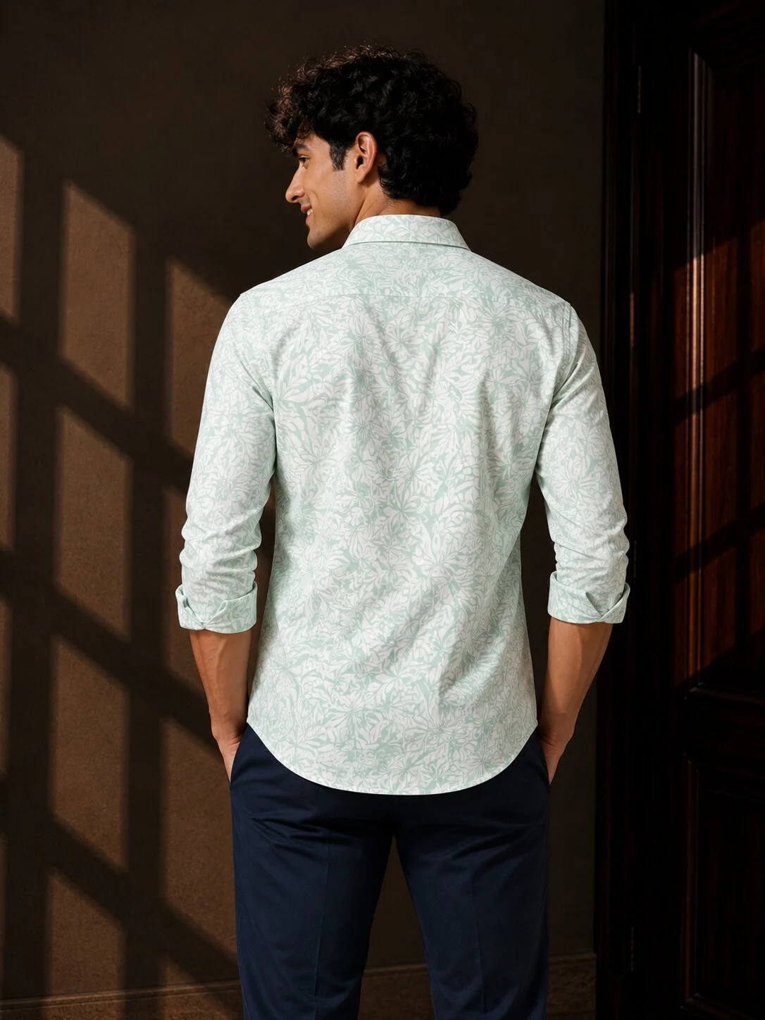 Mint green and white patterned shirt, back view, worn by a model, collar visible, sleeves rolled up