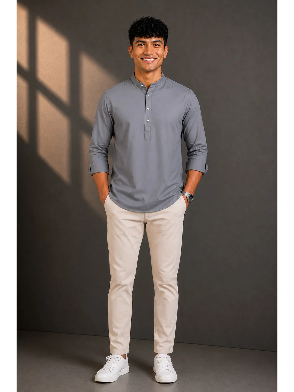 Charcoal grey short kurta with mandarin collar and cuffed sleeves worn by a model