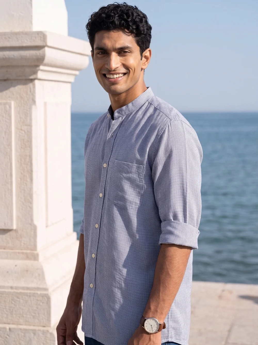 Purple kurta with mandarin collar, buttoned front, long sleeves, and pocket. Worn by a model