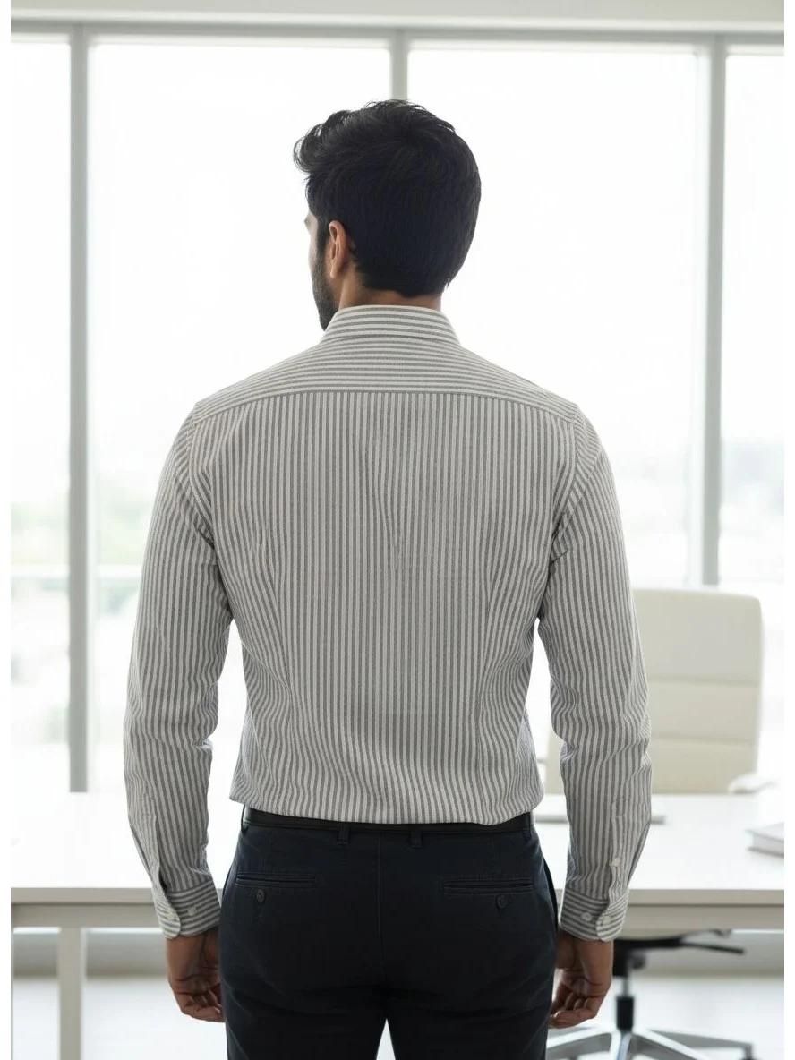Back view of a male model wearing a grey and white striped full-sleeve shirt and dark trousers in an office
