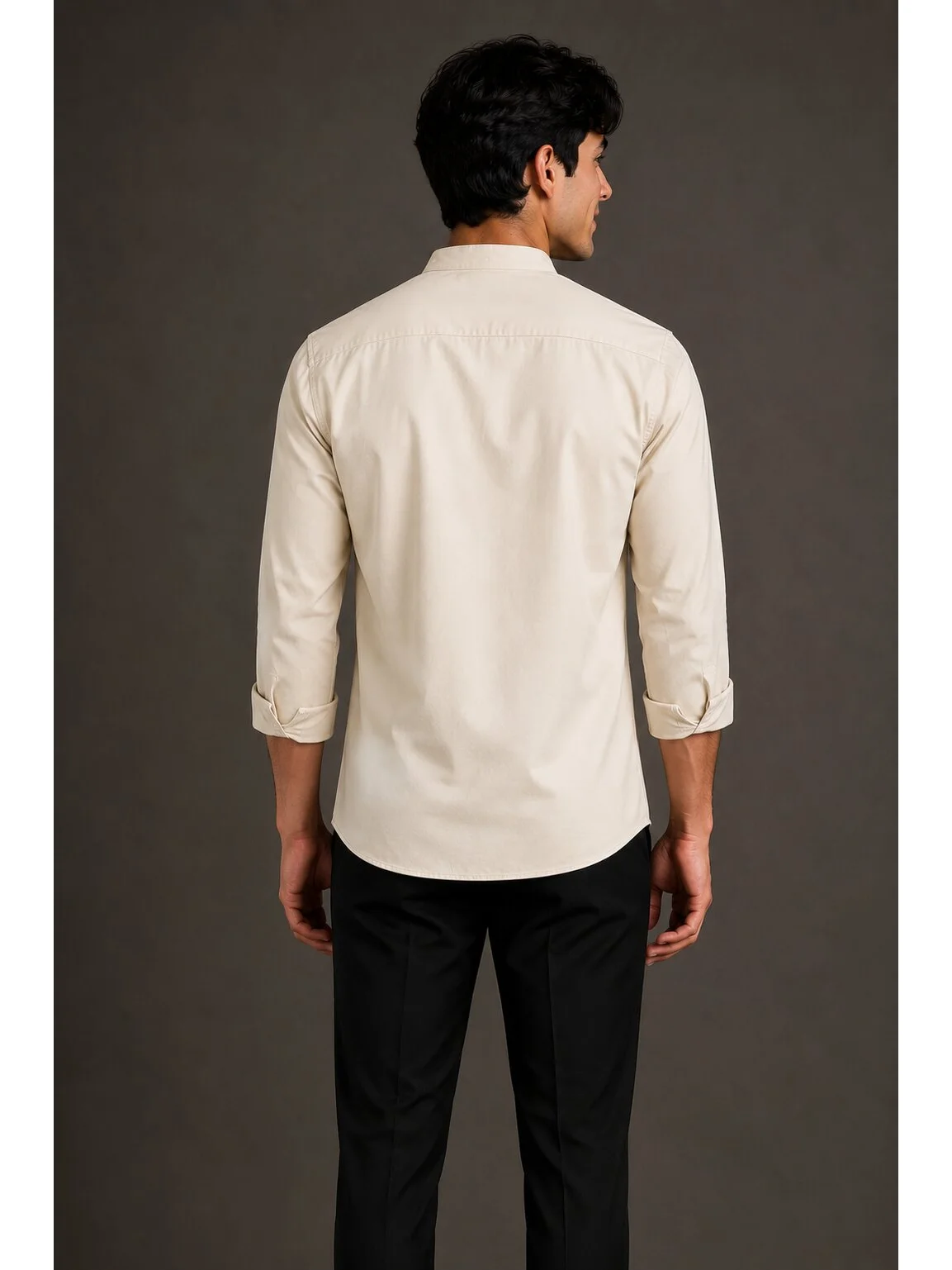 Model wearing back view of solid light beige short kurta with rolled-up sleeves and mandarin collar