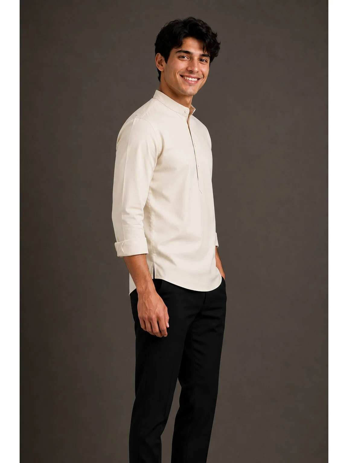 Model wearing light beige short kurta with mandarin collar and rolled-up sleeves, paired with black trousers