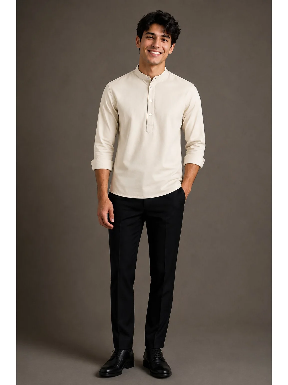 Model wearing light beige short kurta with mandarin collar, button placket, and rolled-up sleeves, paired with black trousers